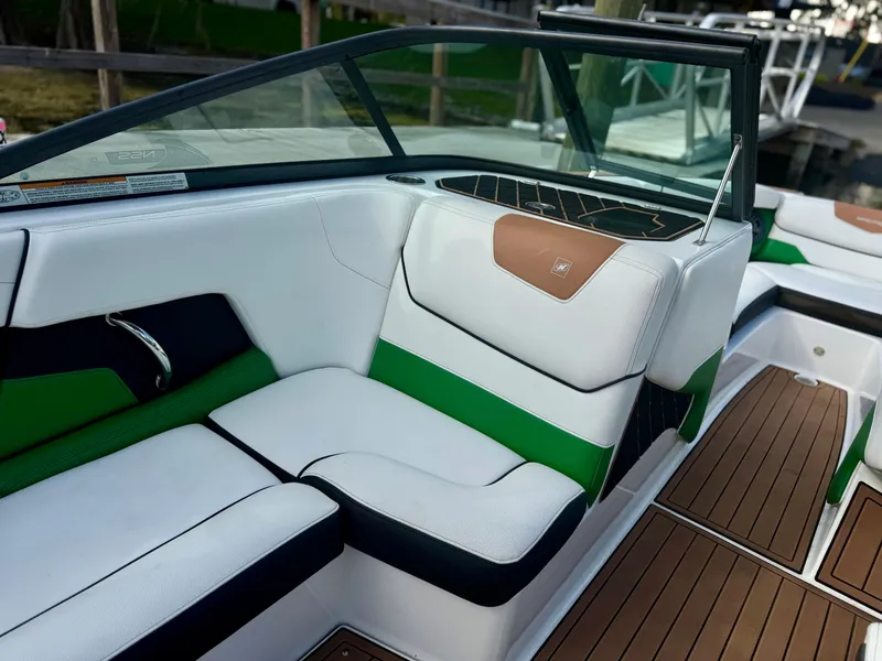 Slide: The Image of 2017 Nautique Super Air Nautique GS20 interior with green, white, and black seating. - 18