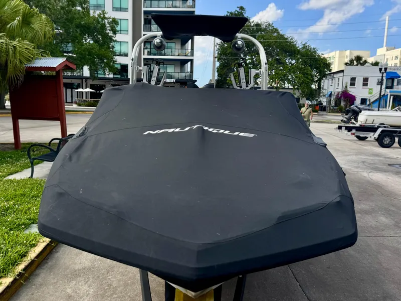 Slide: The Image of 2017 Nautique Super Air Nautique GS20 boat with cover, parked outdoors. - 2