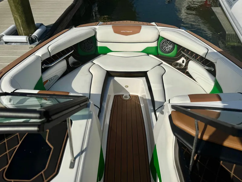 Slide: The Image of 2017 Nautique Super Air Nautique GS20 boat interior with white and green seating. - 20