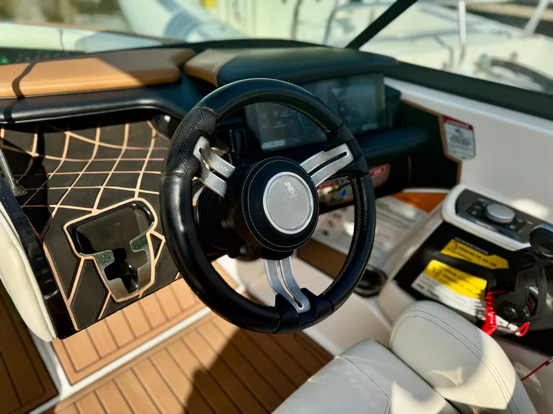 Slide: The Image of Steering wheel of 2017 Nautique Super Air Nautique GS20 boat interior. - 22
