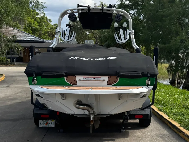 Slide: The Image of 2017 Nautique Super Air Nautique GS20 boat on trailer, covered, parked outdoors. - 3