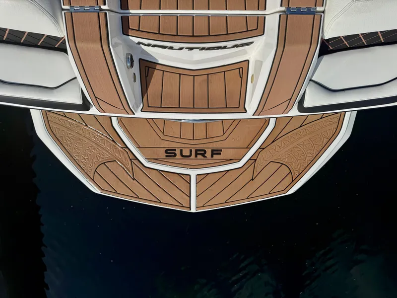 Slide: The Image of 2017 Nautique Super Air Nautique GS20 swim platform with "SURF" text, teak finish. - 6