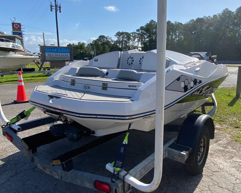 The Image of 2018 Scarab 165 boat on trailer, parked outdoors under clear sky. - 1