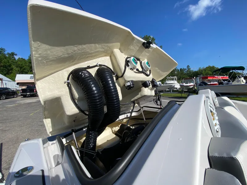 Slide: The Image of 2018 Scarab 165 boat engine compartment open under clear blue sky. - 14