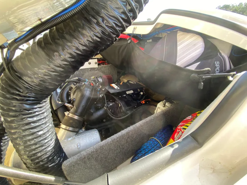 Slide: The Image of Engine compartment of a 2018 Scarab 165 boat, showcasing mechanical components and ventilation system. - 16