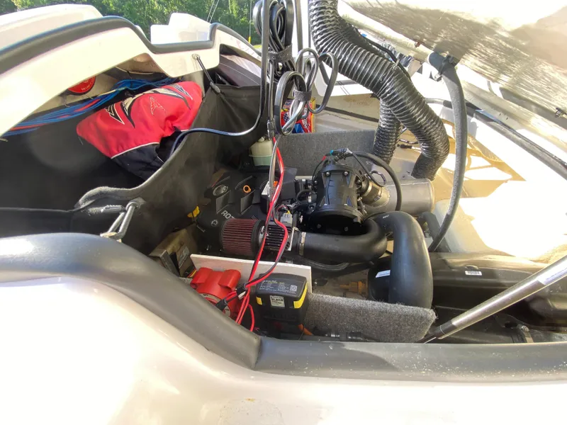 Slide: The Image of Engine compartment of a 2018 Scarab 165 boat, showcasing mechanical components and wiring. - 17
