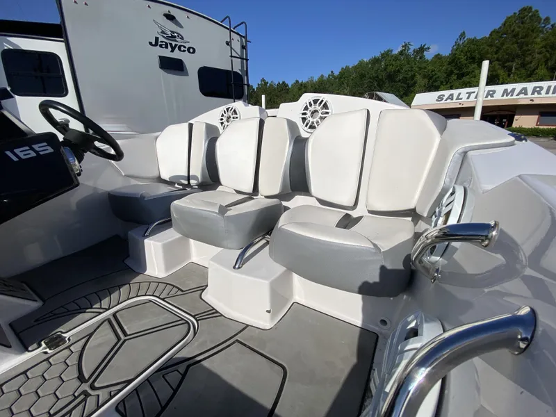 Slide: The Image of 2018 Scarab 165 boat interior with gray seating and steering wheel. - 9