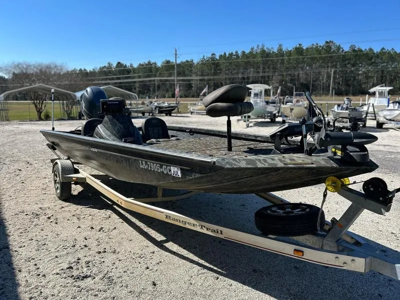 Slide: The Image of 2015 Ranger Tournament RT188 boat on trailer, parked outdoors, clear sky background. - 1