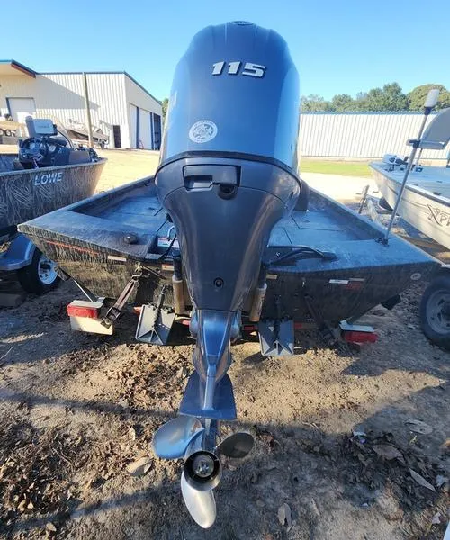 Slide: The Image of 2015 Ranger Tournament RT188 boat with a 115 horsepower outboard motor, parked outdoors. - 12