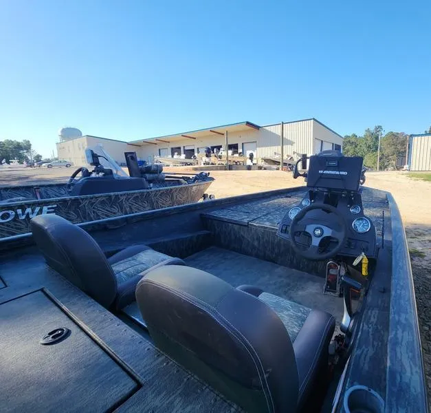 Slide: The Image of 2015 Ranger Tournament RT188 boat interior with steering console, seats, and outdoor storage facility. - 15