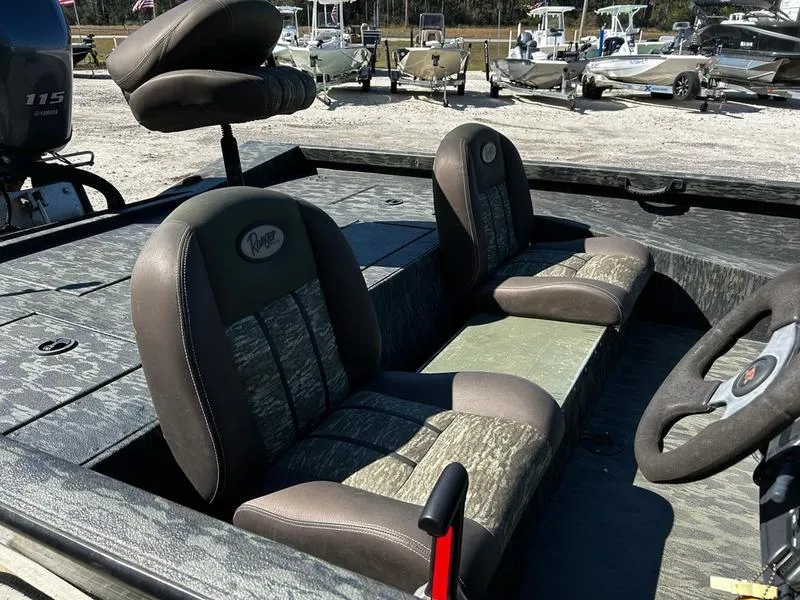 Slide: The Image of 2015 Ranger Tournament RT188 boat interior with cushioned seats and steering wheel. - 18