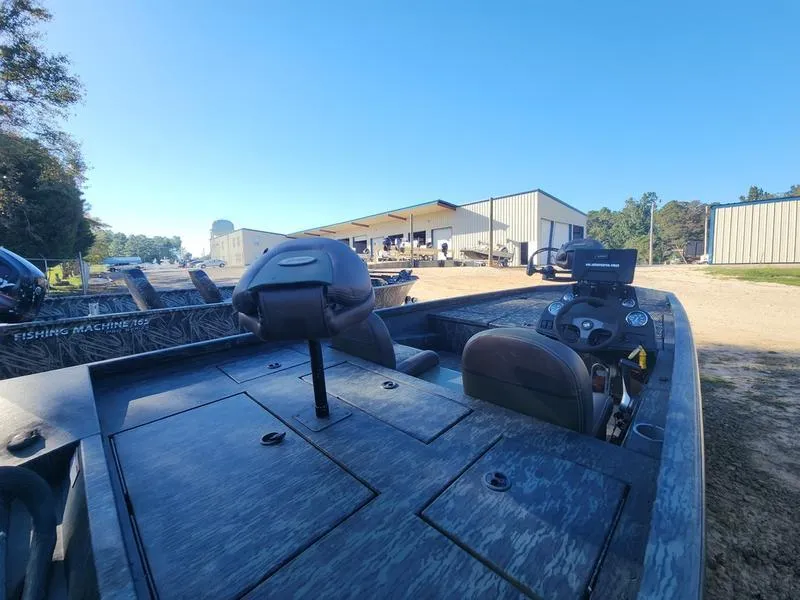 Slide: The Image of 2015 Ranger Tournament RT188 boat parked outdoors near industrial buildings. - 19