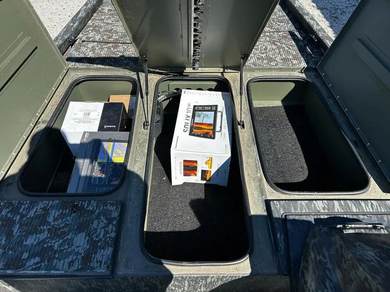 Slide: The Image of 2015 Ranger Tournament RT188 storage compartments with various boxes and equipment inside. - 7