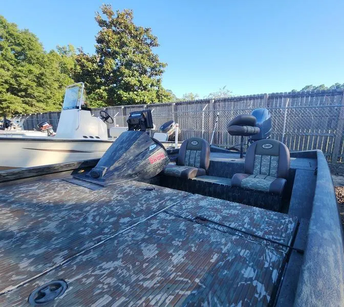 Slide: The Image of 2015 Ranger Tournament RT188 boat with camouflage design, parked outdoors. - 9