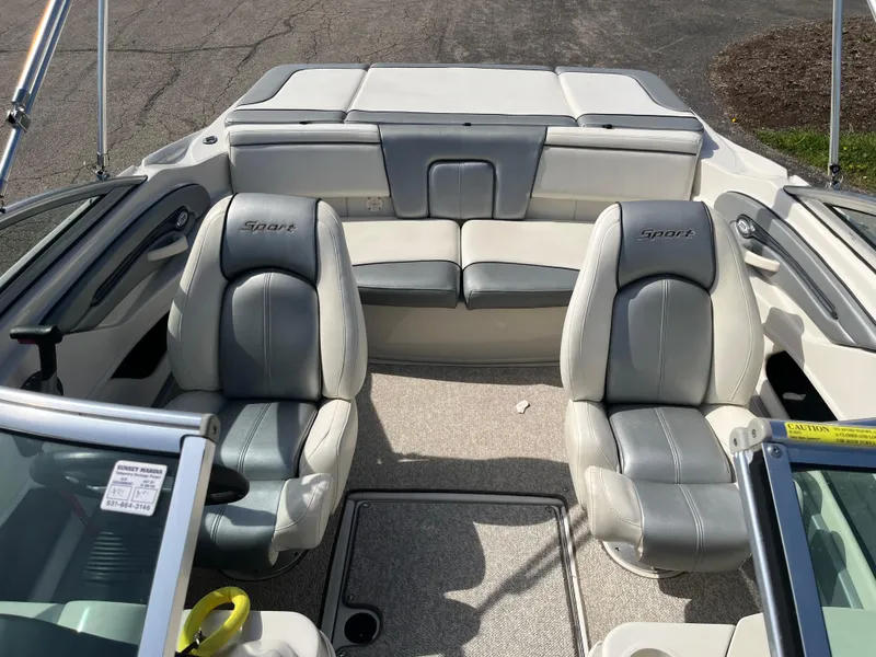 Slide: The Image of 2008 Sea Ray 205 Sport boat interior with gray seating and steering wheel. - 10