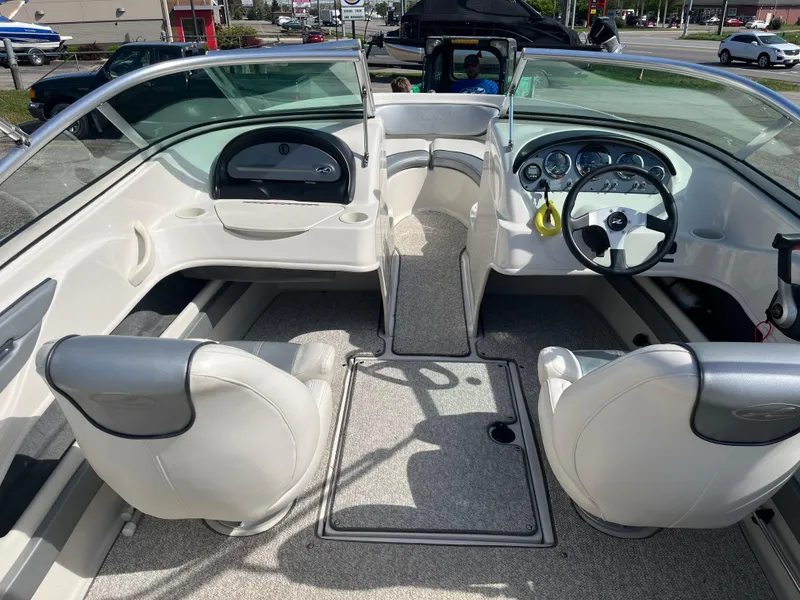 Slide: The Image of 2008 Sea Ray 205 Sport boat interior with steering wheel and seating. - 11