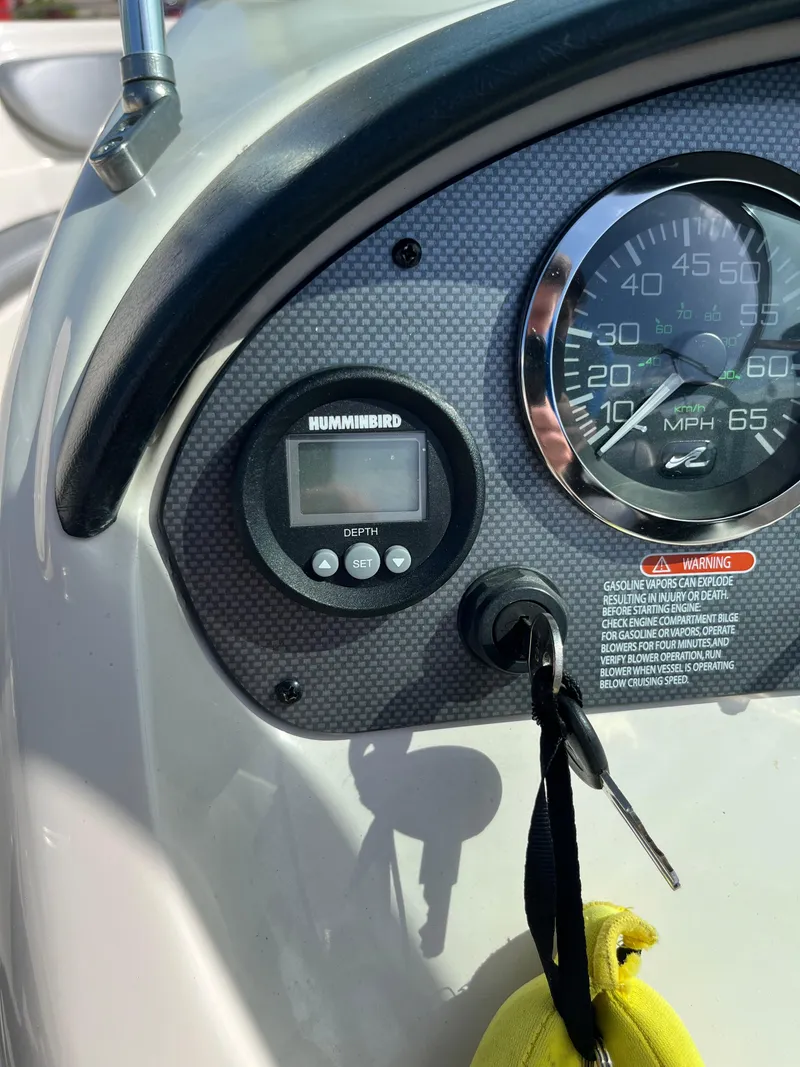 Slide: The Image of Dashboard of a 2008 Sea Ray 205 Sport boat with speedometer and depth gauge. - 12