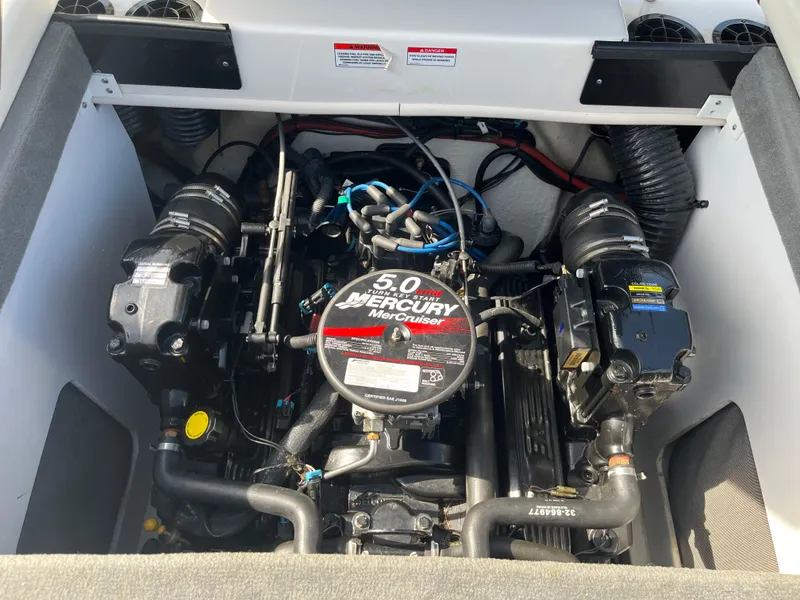 Slide: The Image of Engine of a 2008 Sea Ray 205 Sport boat, featuring a 5.0 Mercury MerCruiser. - 13