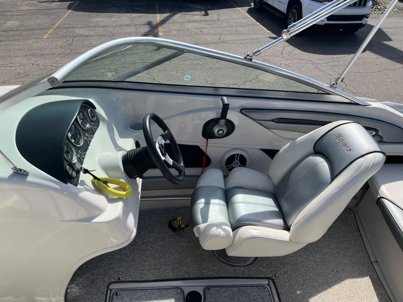 Slide: The Image of 2008 Sea Ray 205 Sport boat interior with steering wheel and seating. - 14