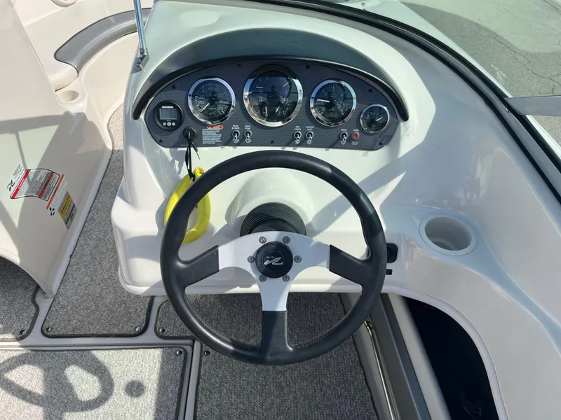 Slide: The Image of 2008 Sea Ray 205 Sport dashboard with steering wheel and instrument panel. - 15
