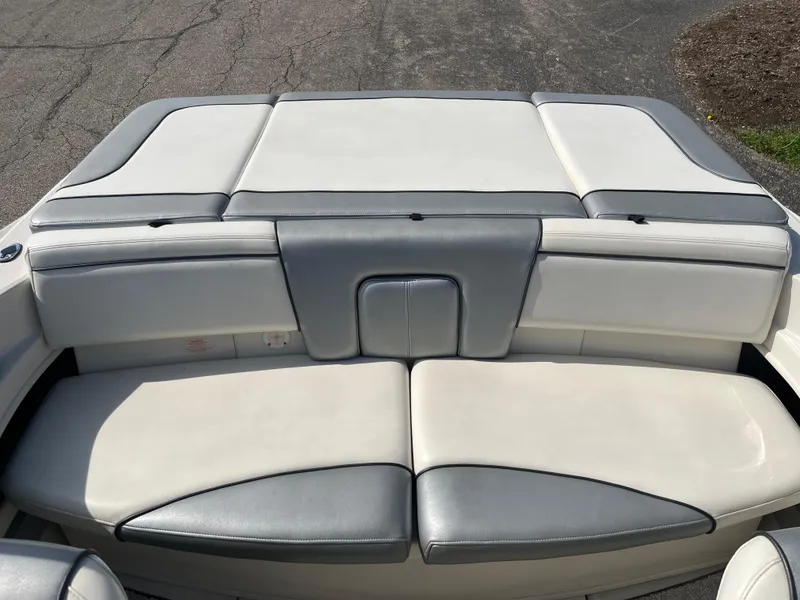 Slide: The Image of 2008 Sea Ray 205 Sport boat seating area with gray and white upholstery. - 5