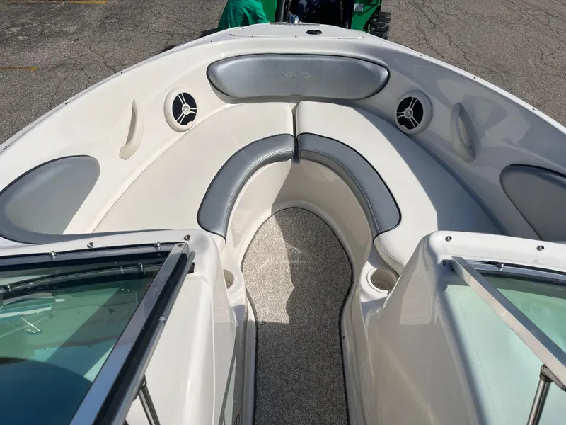 Slide: The Image of 2008 Sea Ray 205 Sport boat interior with cushioned seating and speakers. - 8