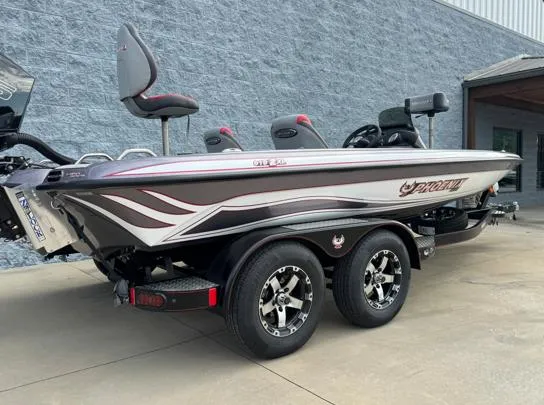 Slide: The Image of 2025 Phoenix 919ZXL boat on trailer, sleek design, dual axles, parked outdoors. - 7