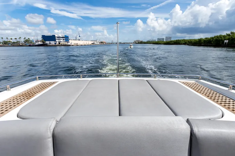 Slide: The Image of Cheoy Lee 76 Alpha yacht, 2012 model, cruising on a sunny day with scenic waterway views. - 11