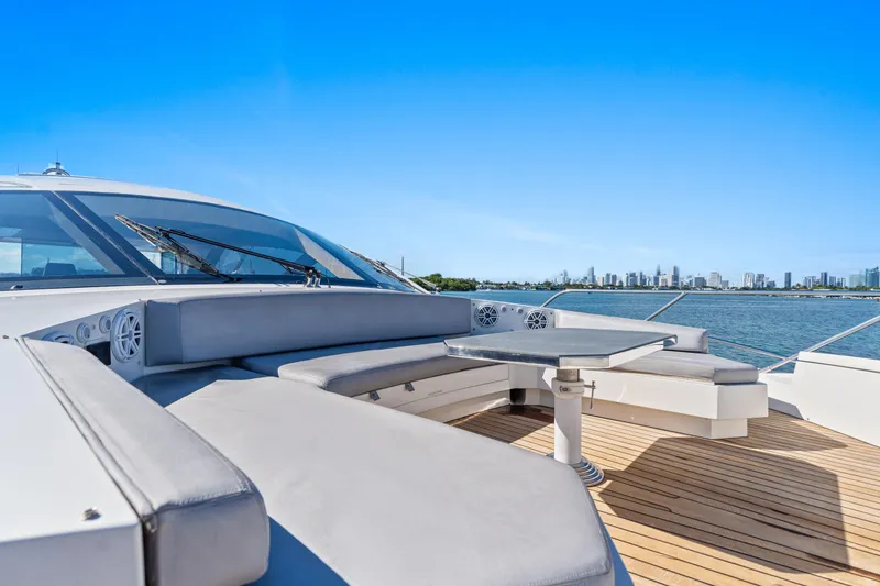 Slide: The Image of Luxurious 2012 Cheoy Lee 76 Alpha yacht deck with seating, overlooking city skyline and water. - 18