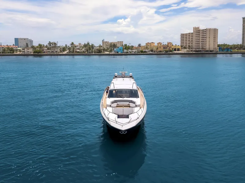 Slide: The Image of Luxury 2012 Cheoy Lee 76 Alpha yacht on calm blue water, cityscape in background. - 2