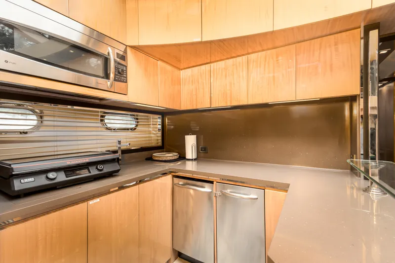 Slide: The Image of Modern kitchen interior of 2012 Cheoy Lee 76 Alpha yacht with wood cabinetry and stainless appliances. - 31