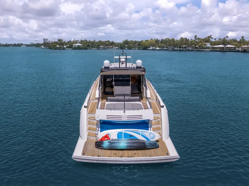 Slide: The Image of 2012 Cheoy Lee 76 Alpha yacht on calm water, rear view with water sports equipment. - 6