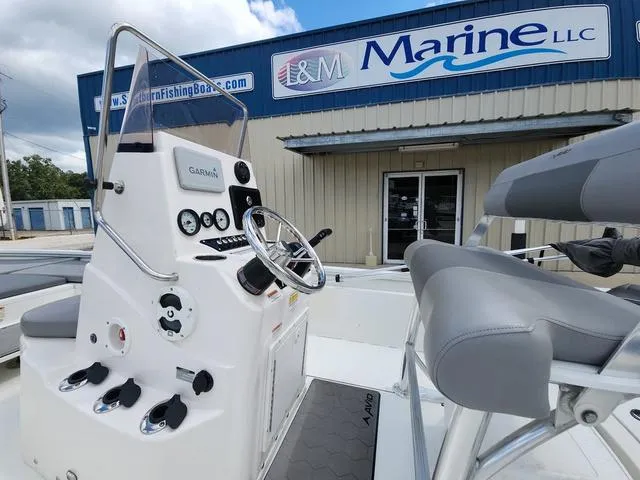 Slide: The Image of 2021 Avid 21 FS boat at I&M Marine dealership, featuring Garmin navigation system. - 10