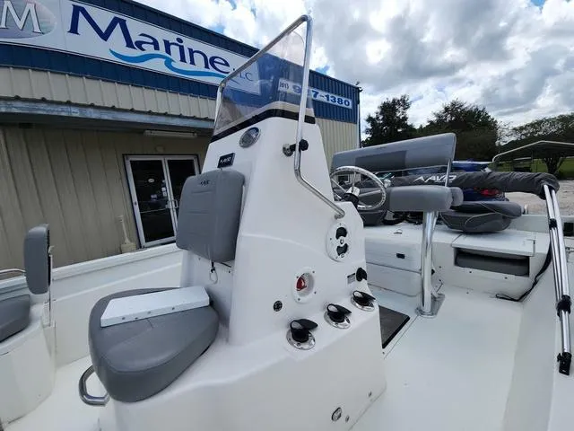 Slide: The Image of 2021 Avid 21 FS boat console with seating, displayed outside a marine dealership. - 16