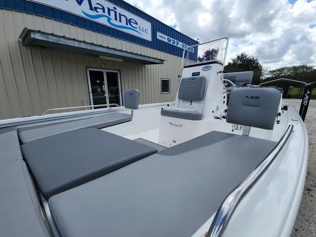 Slide: The Image of 2021 Avid 21 FS boat with gray seating, displayed outside a marine dealership. - 17