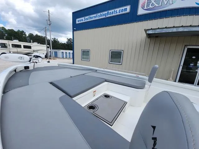 Slide: The Image of 2021 Avid 21 FS boat with gray seating, parked outside Southern Fishing Boats store. - 19