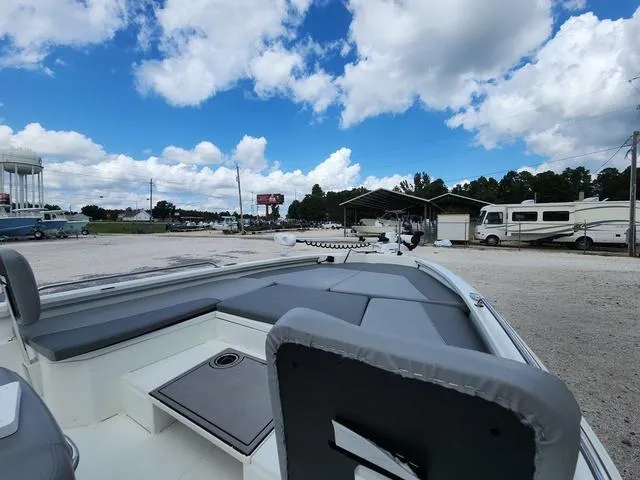 Slide: The Image of Avid 21 FS boat, 2021 model, parked outdoors under a vibrant blue sky. - 26