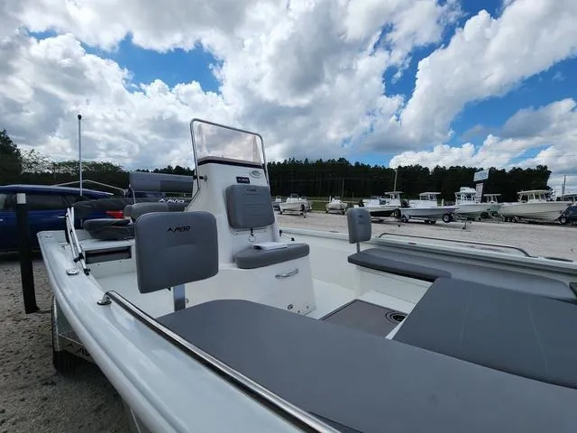 Slide: The Image of Avid 21 FS boat, 2021 model, parked outdoors under a partly cloudy sky. - 27