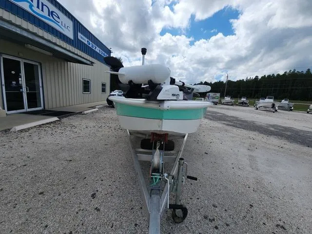 Slide: The Image of 2021 Avid 21 FS boat on trailer outside a building under a cloudy sky. - 7