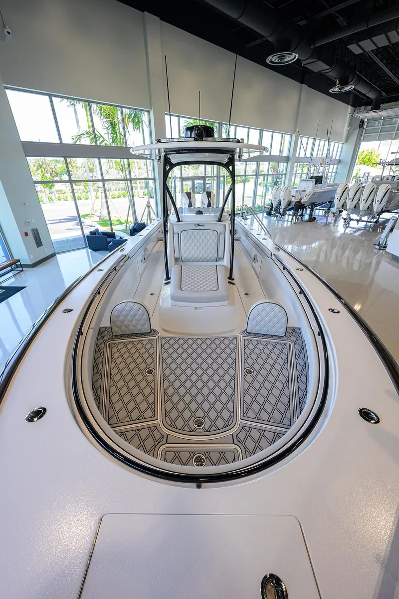 Slide: The Image of 2025 Valhalla Boatworks V-29 in showroom, showcasing sleek design and spacious deck. - 10