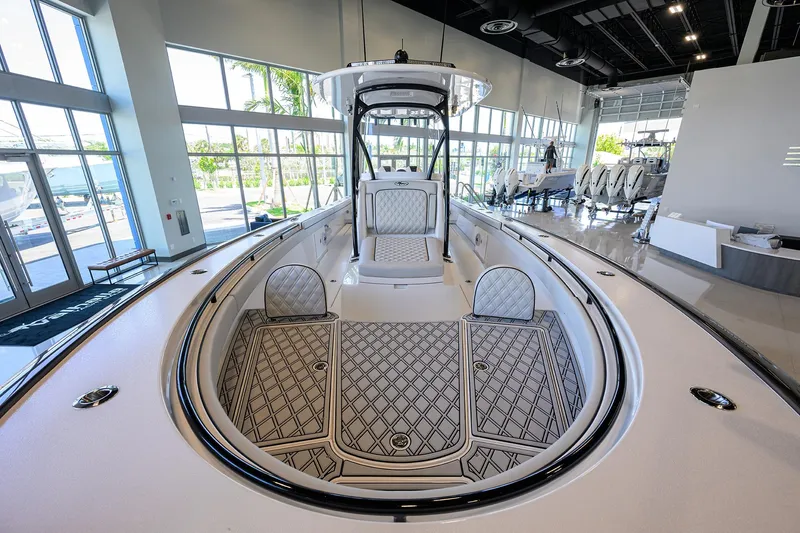 Slide: The Image of 2025 Valhalla Boatworks V-29 in showroom, showcasing sleek design and spacious deck. - 11