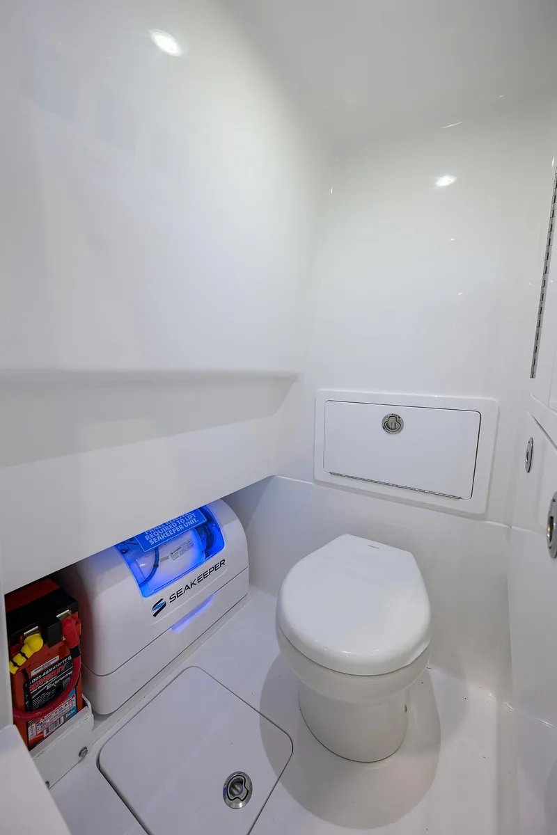 Slide: The Image of 2025 Valhalla Boatworks V-29 interior bathroom with modern white fixtures and storage. - 17
