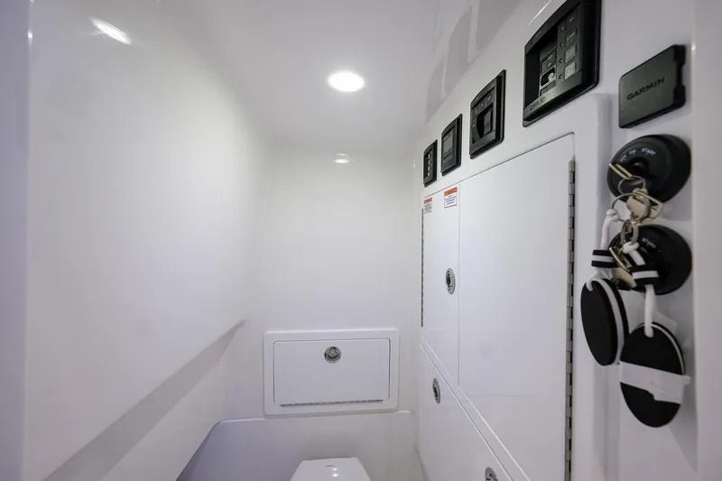 Slide: The Image of 2025 Valhalla Boatworks V-29 interior with sleek white cabinetry and modern controls. - 19