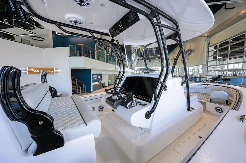 Slide: The Image of 2025 Valhalla Boatworks V-29 interior with modern helm and seating in showroom. - 20