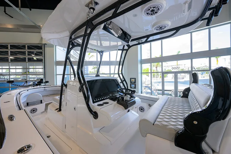 Slide: The Image of 2025 Valhalla Boatworks V-29 interior with modern helm and seating in showroom. - 25