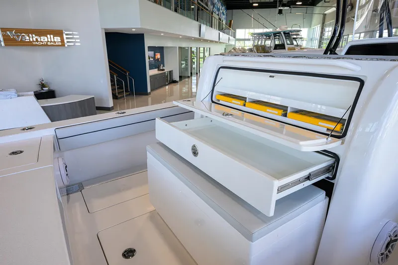Slide: The Image of 2025 Valhalla Boatworks V-29 interior with open storage compartments in a showroom setting. - 45