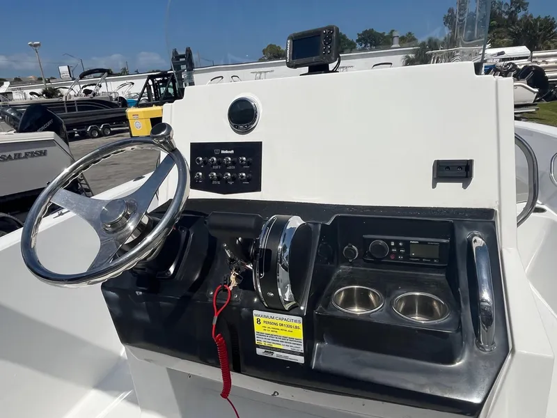 Slide: The Image of 2022 Wellcraft 202 Fisherman boat console with steering wheel and controls. - 12