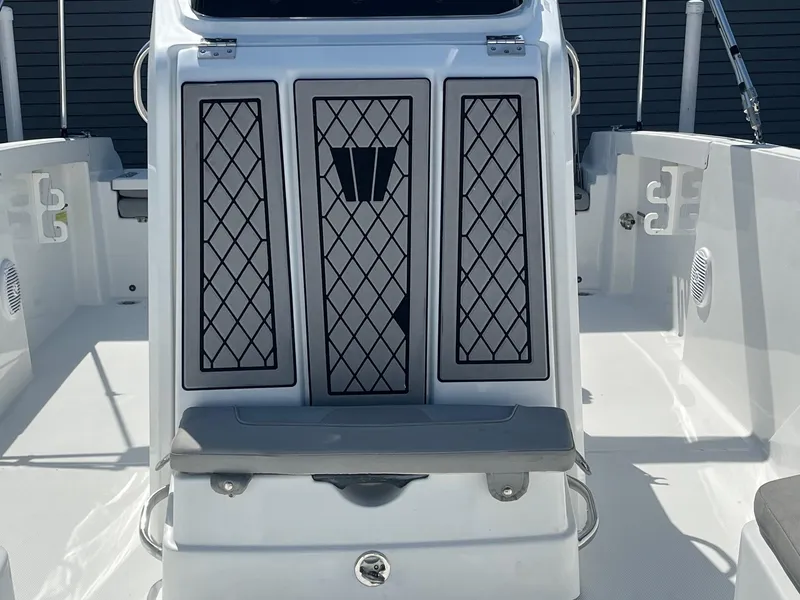 Slide: The Image of 2022 Wellcraft 202 Fisherman boat interior with cushioned seating and storage compartments. - 13