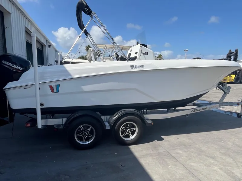 Slide: The Image of 2022 Wellcraft 202 Fisherman boat on trailer, parked outdoors under blue sky. - 4