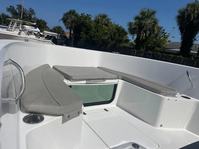 Slide: The Image of 2022 Wellcraft 202 Fisherman boat interior with cushioned seating and cup holders. - 6